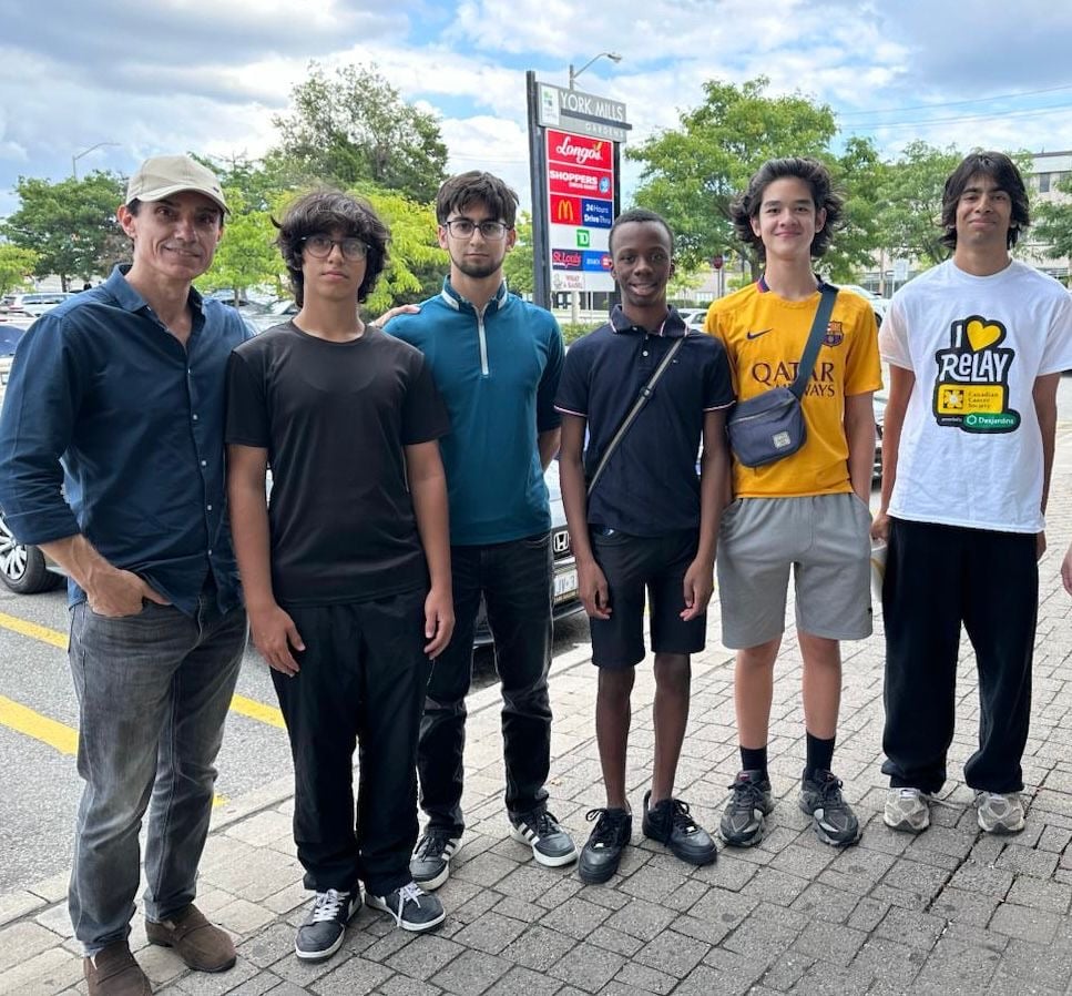 Sinan Erdemir with a group of local teenagers outside the York Mills Gardens plaza