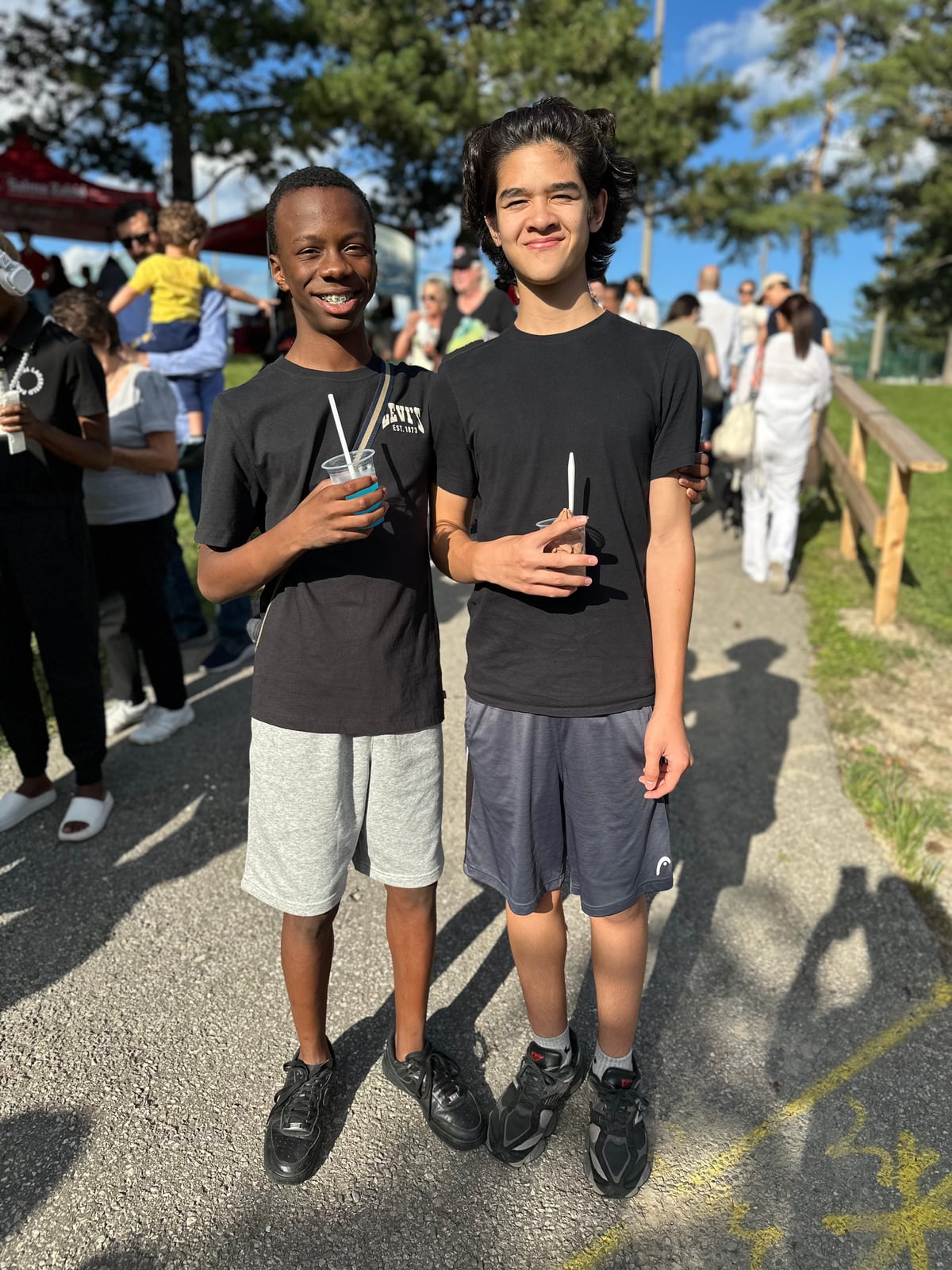 Two young residents with cold drinks at a Don Valley East community event