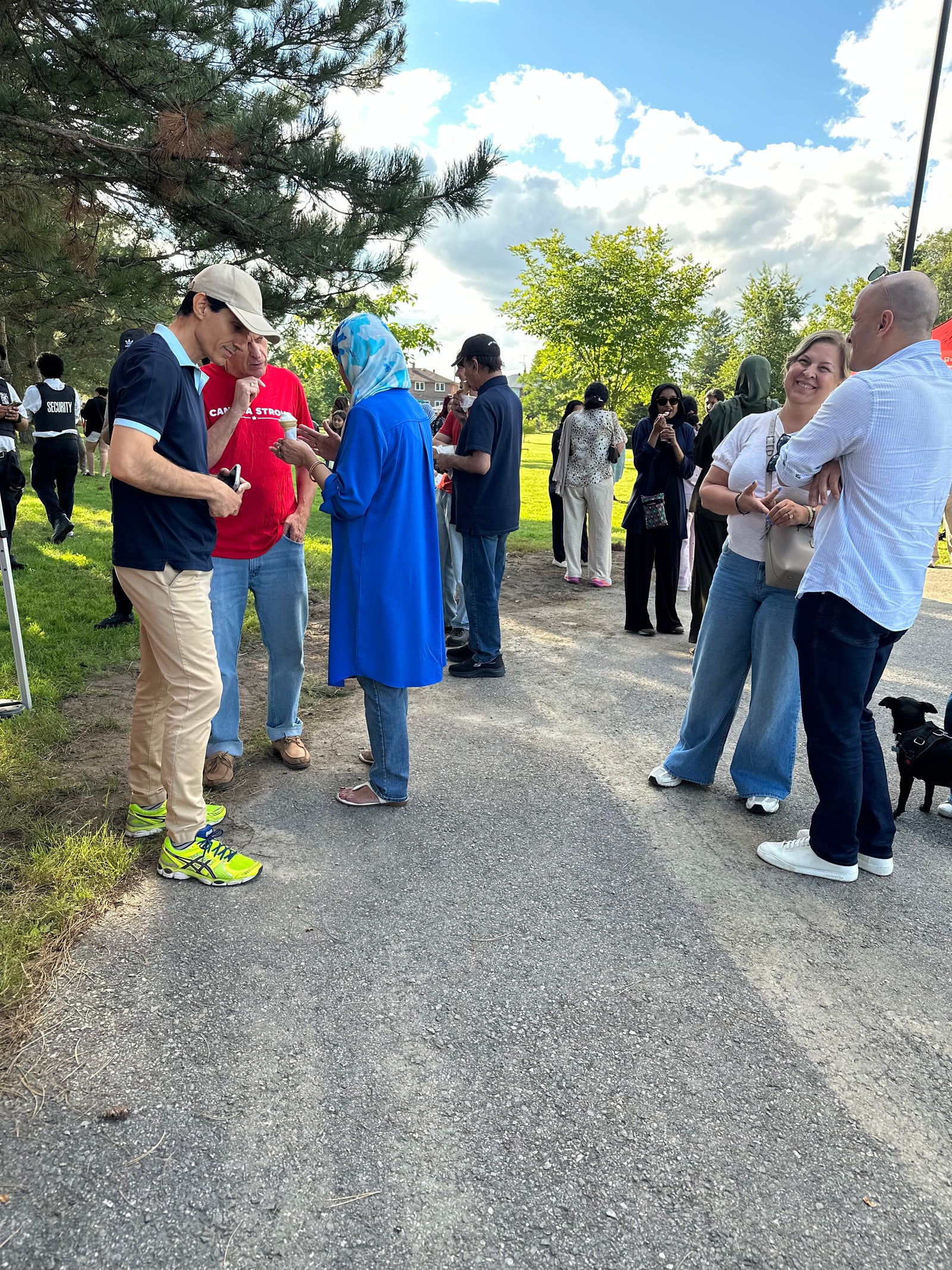 Sinan Erdemir chatting with neighbours over ice cream at a park event